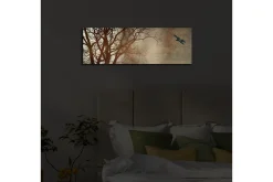 Lerretsbilde med LED-belysning 30x90 cm - Silhuett av et tre med en fugl i flukt mot en mykt tonet bakgrunn